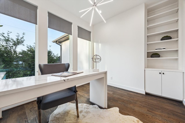 home office featuring dark wood finished floors, baseboards, a chandelier, and built in features