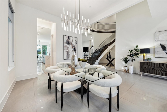 tiled dining room featuring stairway and baseboards