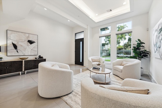 living area with recessed lighting, a high ceiling, light tile patterned flooring, and baseboards
