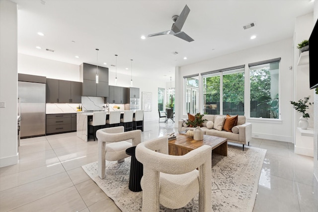 living area featuring a ceiling fan, recessed lighting, light tile patterned floors, and baseboards