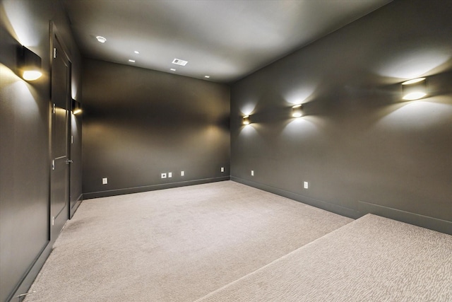 empty room featuring carpet floors, baseboards, and recessed lighting