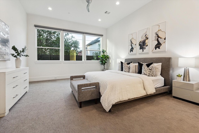 bedroom with light carpet, recessed lighting, and baseboards