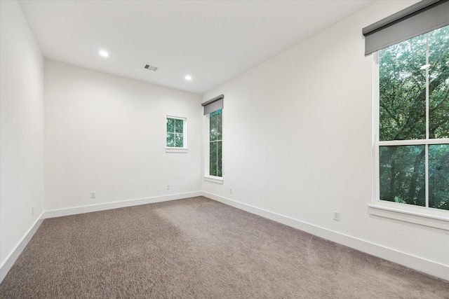 unfurnished room featuring plenty of natural light, carpet flooring, recessed lighting, and baseboards