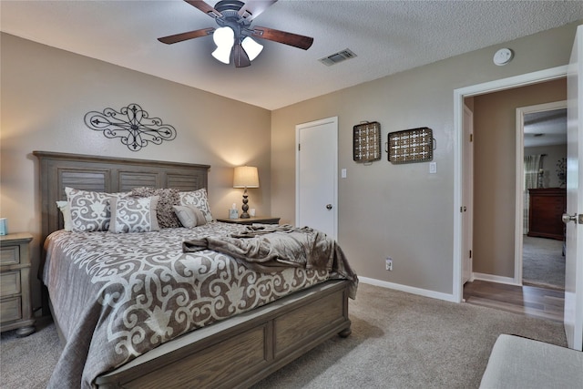 carpeted bedroom with baseboards and a ceiling fan
