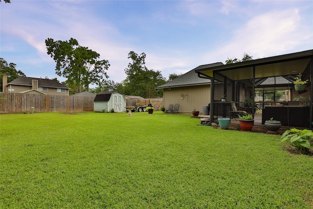 view of yard featuring a shed, an outdoor structure, and a hot tub