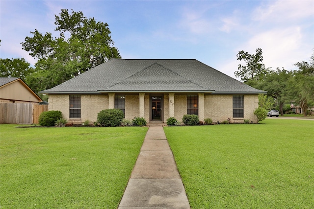 ranch-style house featuring brick siding and a shingled roof