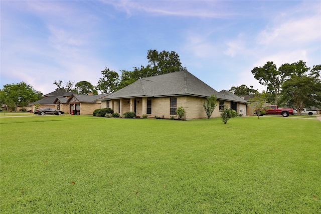 view of front facade featuring a front lawn and brick siding
