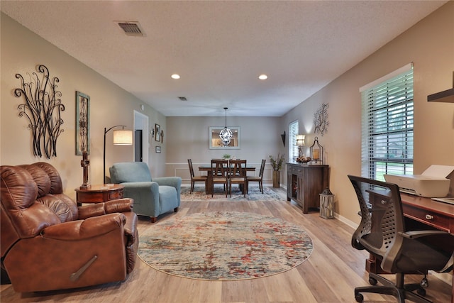 living area with light wood finished floors, recessed lighting, and baseboards