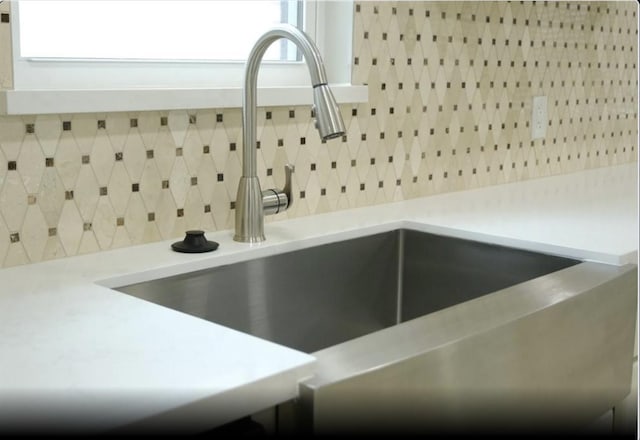 1703 Grand Valley Dr, Houston, TX 77090 - kitchen view of a sink, decorative backsplash, and light countertops