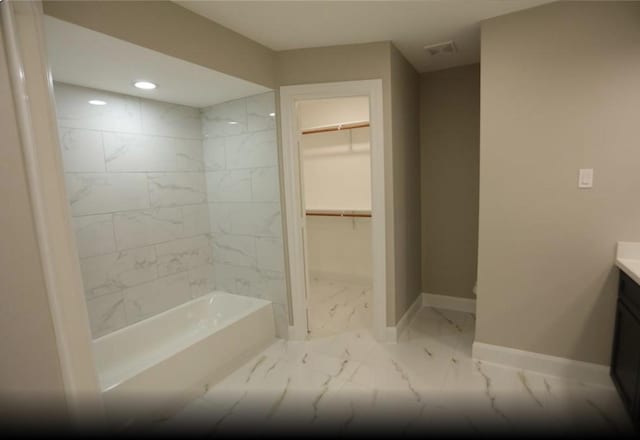 1703 Grand Valley Dr, Houston, TX 77090 - bathroom featuring marble finish flooring, vanity, baseboards, a walk in closet, and recessed lighting