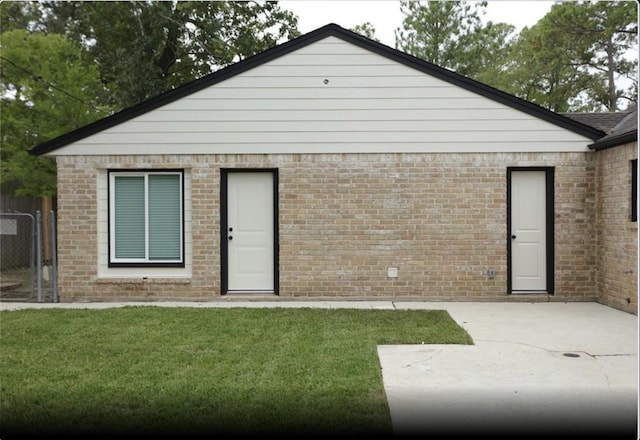 1703 Grand Valley Dr, Houston, TX 77090 - rear view of property featuring brick siding and a patio
