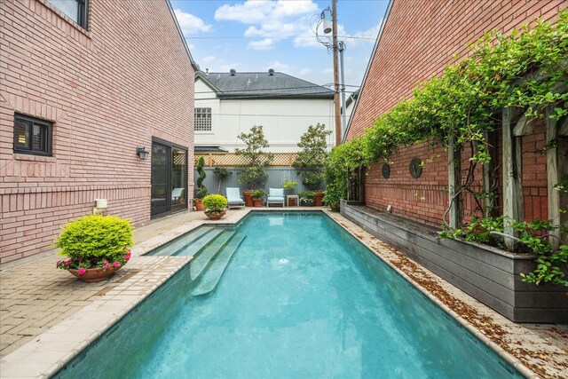 view of swimming pool featuring a fenced backyard