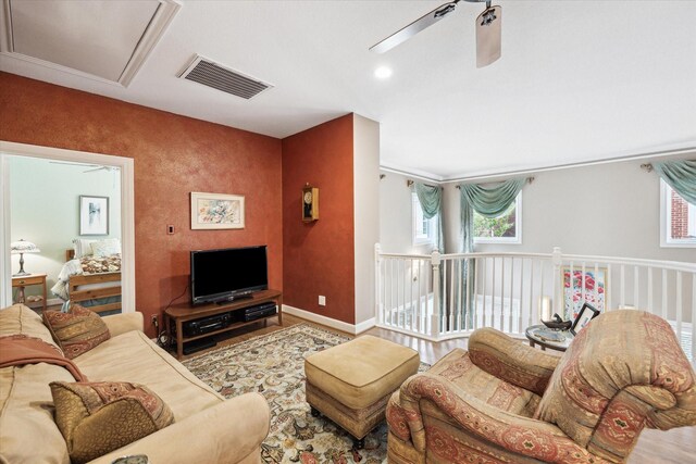 living room with baseboards and attic access