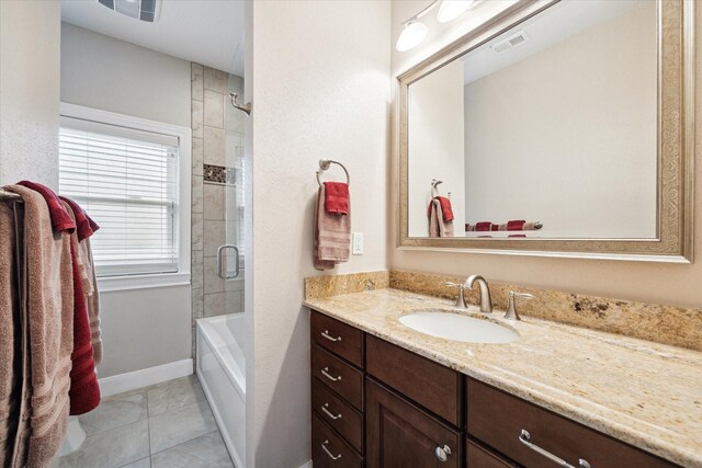 bathroom featuring vanity, tile patterned floors, baseboards, and shower / bath combination
