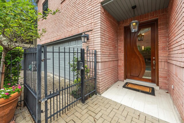 property entrance featuring brick siding and a gate