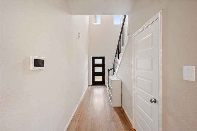 104 Clay Creek Ln, Montgomery, TX 77316 - entryway featuring light wood-style floors, baseboards, stairs, and a towering ceiling