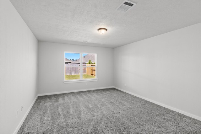 3017 Pampaneria Dr, Conroe, TX 77301 - spare room with carpet floors, a textured ceiling, and baseboards