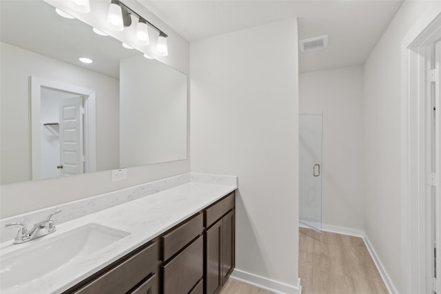 3017 Pampaneria Dr, Conroe, TX 77301 - bathroom with wood finished floors, vanity, a shower stall, and baseboards