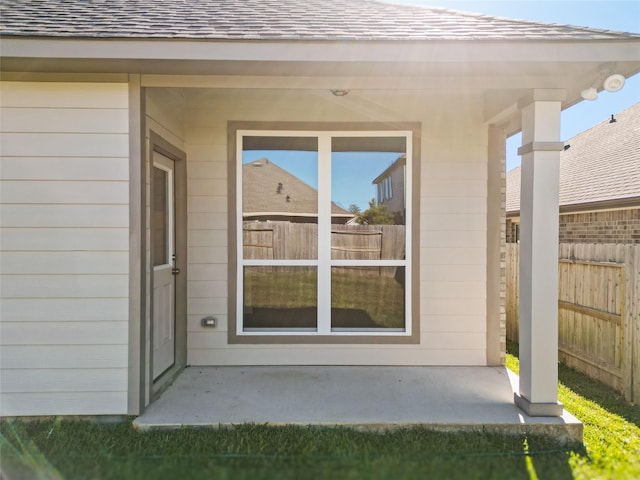 3017 Pampaneria Dr, Conroe, TX 77301 - doorway to property featuring fence and roof with shingles