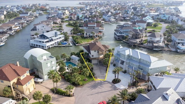 aerial view of residential area featuring a large body of water