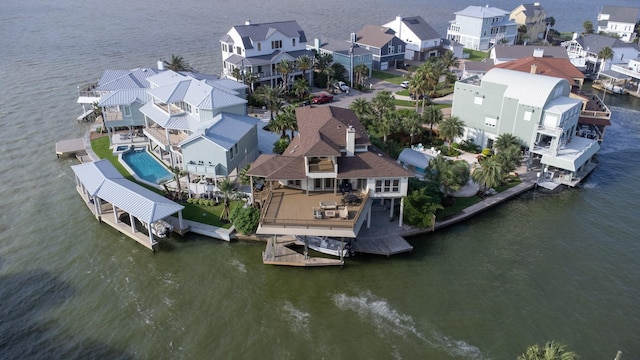 aerial view of residential area featuring a large body of water