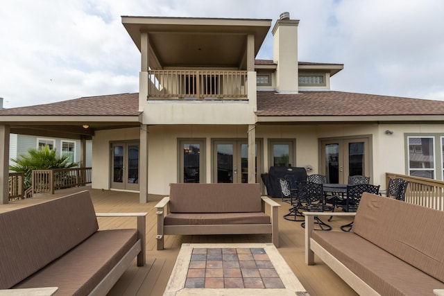back of house with french doors, an outdoor hangout area, and a balcony