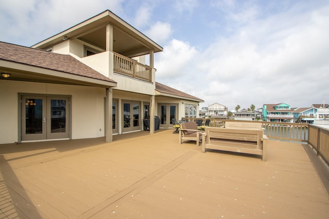 view of patio with french doors and a balcony