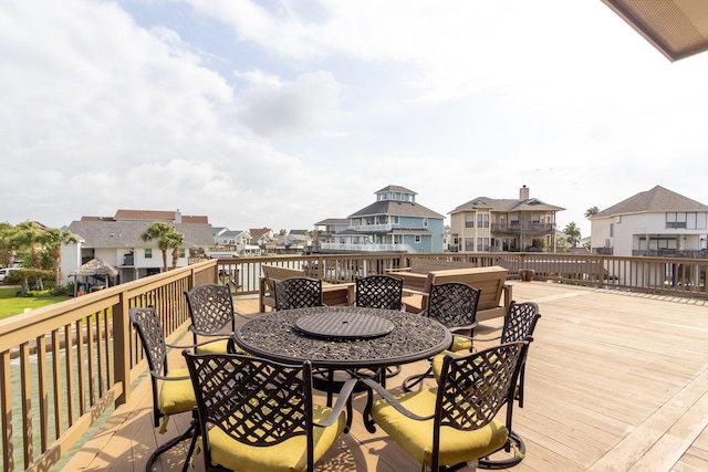 deck featuring a residential view and outdoor dining area