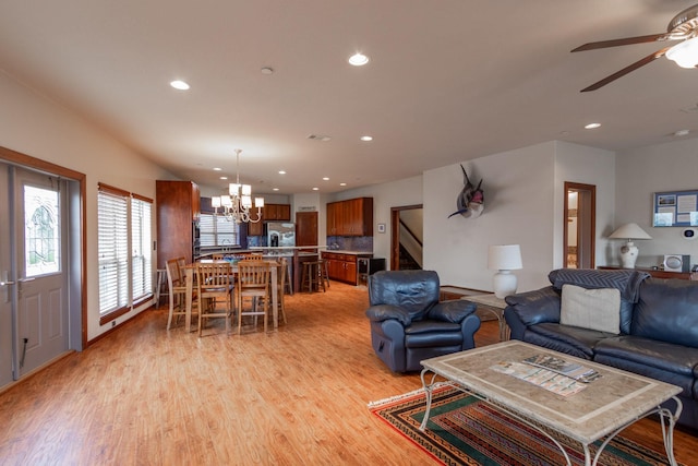 living area featuring light wood-type flooring, a chandelier, ceiling fan, and recessed lighting