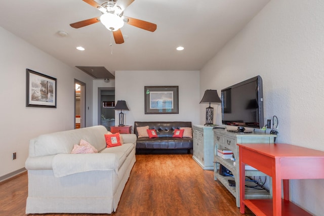 living room with wood finished floors, ceiling fan, attic access, and recessed lighting