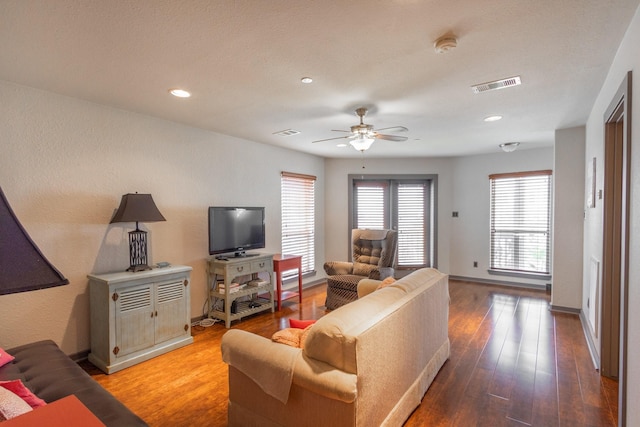 living area featuring wood-type flooring, a ceiling fan, baseboards, and recessed lighting