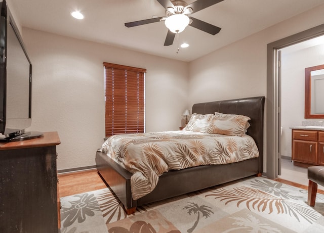 bedroom with light wood-style floors, recessed lighting, baseboards, ceiling fan, and ensuite bathroom