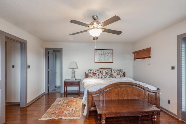 bedroom with wood finished floors, baseboards, and ceiling fan
