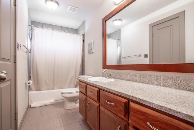 bathroom featuring vanity, toilet, and shower / bath combo with shower curtain