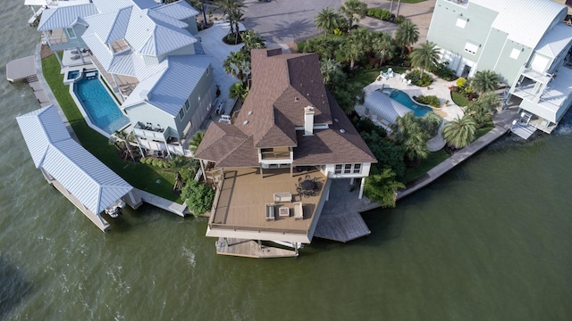 drone / aerial view of a pool and a large body of water
