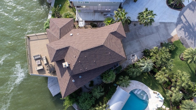 view of subject property with a nearby body of water and a pool area