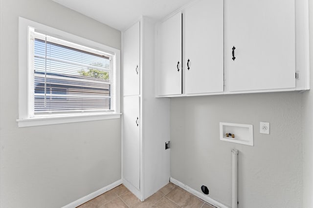 clothes washing area featuring hookup for an electric dryer, cabinet space, washer hookup, baseboards, and light tile patterned floors