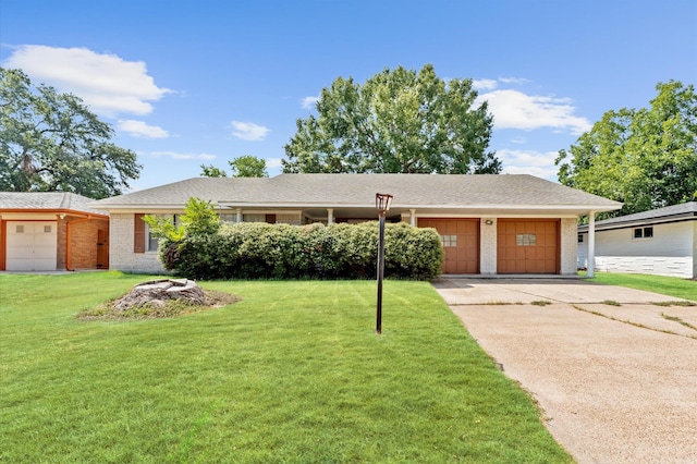 single story home featuring an attached garage, brick siding, a front lawn, and driveway