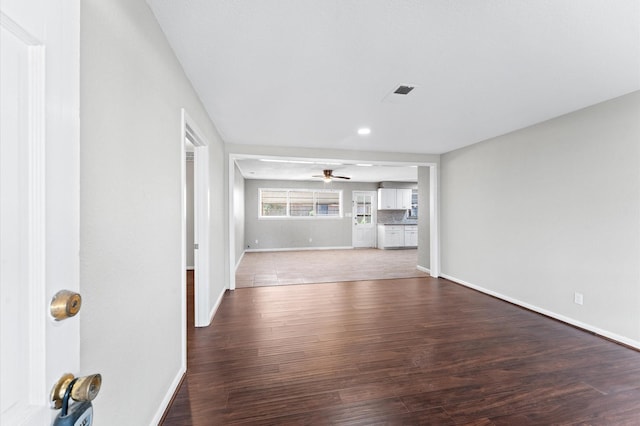 unfurnished living room with dark wood finished floors, a ceiling fan, baseboards, and recessed lighting