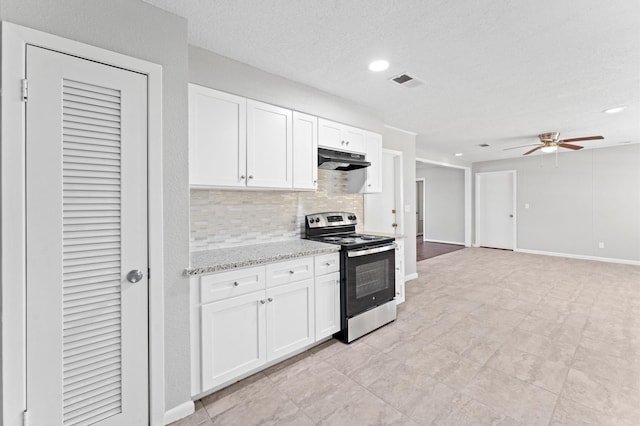 kitchen with stainless steel electric range oven, under cabinet range hood, decorative backsplash, ceiling fan, and white cabinets