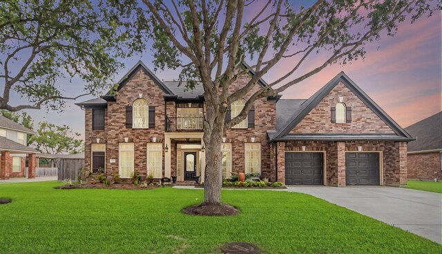traditional home with a balcony, driveway, and brick siding