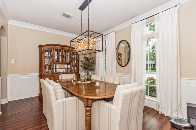 1886 Pampas Trail Dr, Friendswood, TX 77546 - dining space with crown molding, a chandelier, dark wood finished floors, wainscoting, and a decorative wall