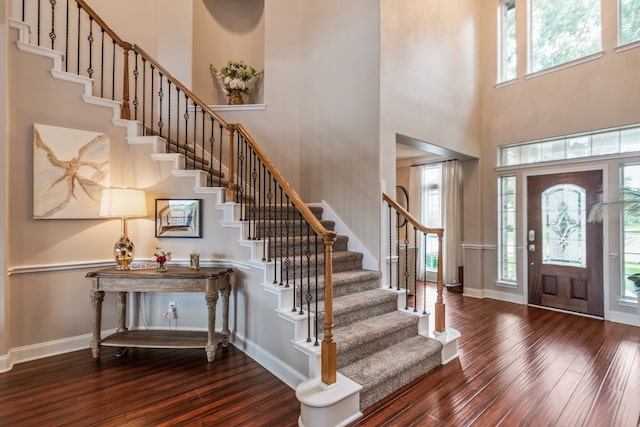 1886 Pampas Trail Dr, Friendswood, TX 77546 - foyer entrance featuring a towering ceiling, stairs, hardwood / wood-style floors, and baseboards