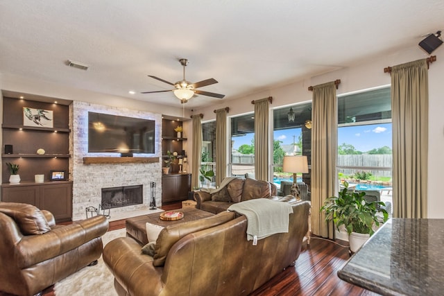 1886 Pampas Trail Dr, Friendswood, TX 77546 - living area with a ceiling fan, dark wood-style flooring, a fireplace, and built in features