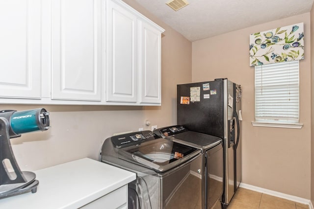 1886 Pampas Trail Dr, Friendswood, TX 77546 - washroom featuring cabinet space, washer and clothes dryer, light tile patterned floors, and baseboards