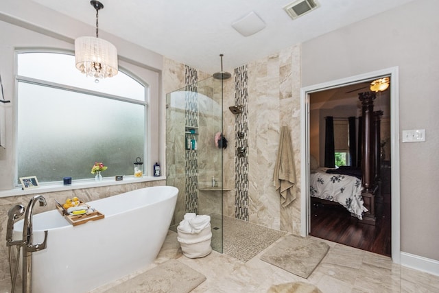 1886 Pampas Trail Dr, Friendswood, TX 77546 - bathroom featuring a freestanding tub, a walk in shower, ensuite bathroom, a chandelier, and tile walls