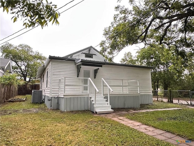 rear view of house featuring cooling unit