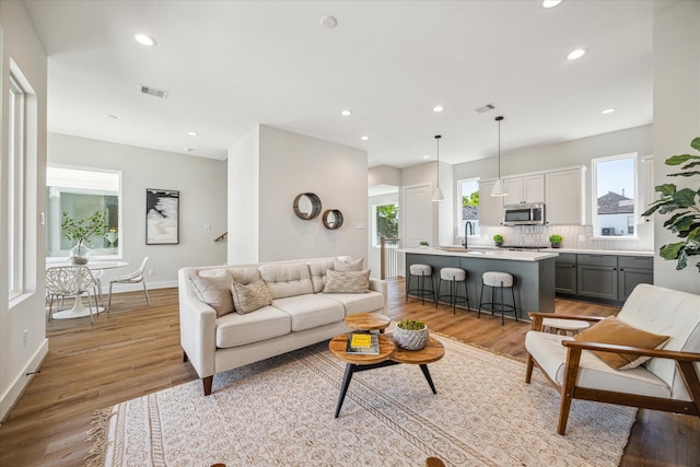 526 Janisch Rd, Houston, TX 77018 - living room featuring light wood-style floors, recessed lighting, and baseboards