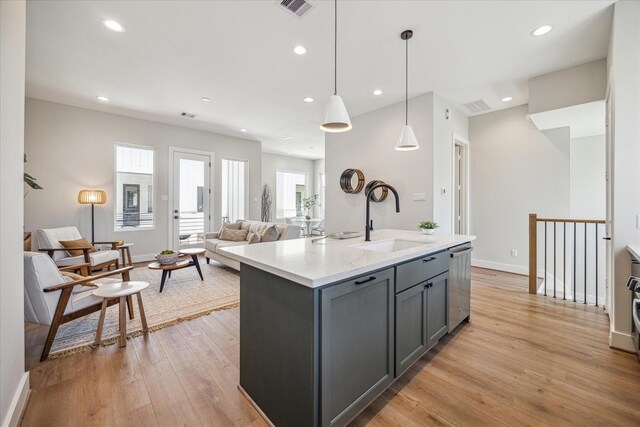 526 Janisch Rd, Houston, TX 77018 - kitchen with a sink, gray cabinets, dishwasher, light wood finished floors, and recessed lighting
