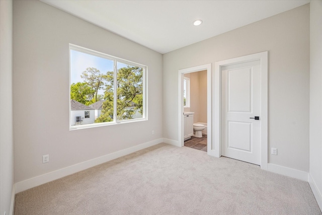 526 Janisch Rd, Houston, TX 77018 - unfurnished bedroom featuring carpet floors, baseboards, connected bathroom, and recessed lighting